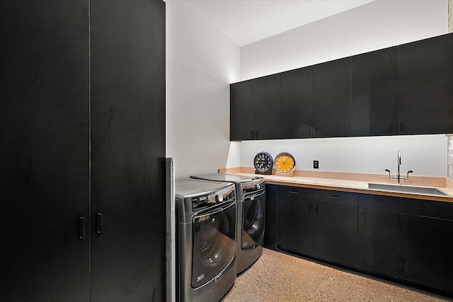 washroom featuring cabinets, washer and dryer, and sink