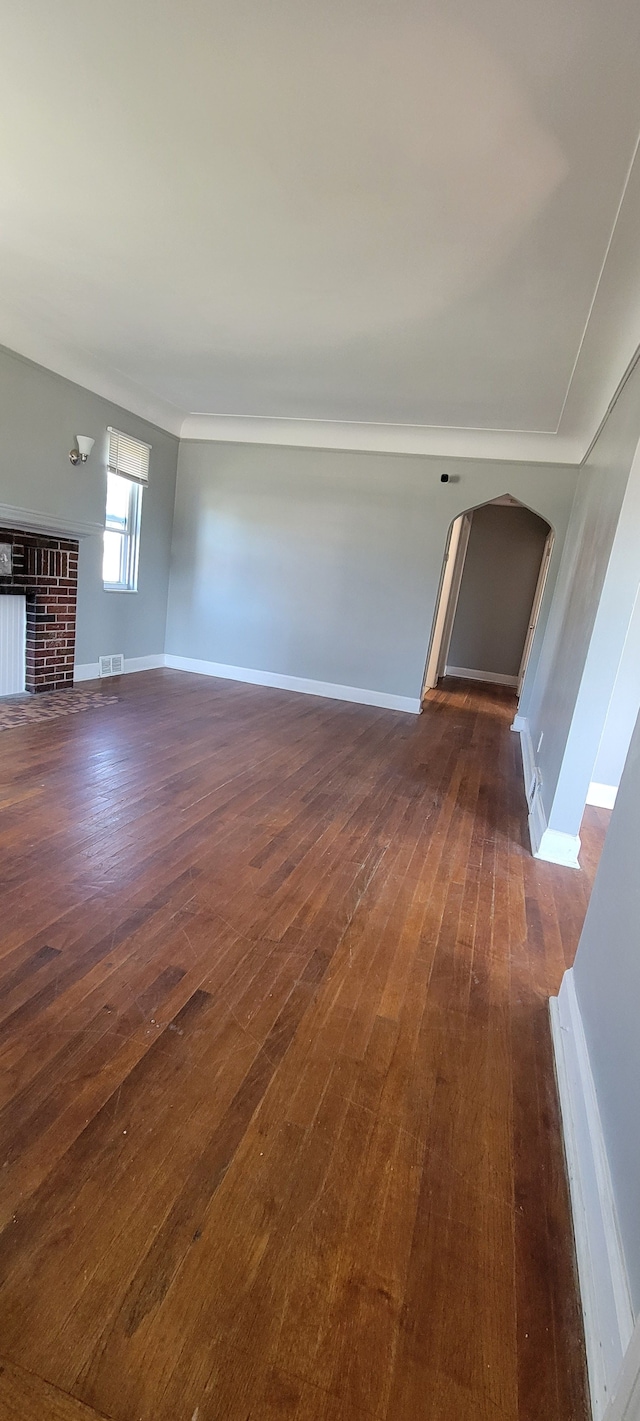 unfurnished living room with a fireplace and dark hardwood / wood-style flooring