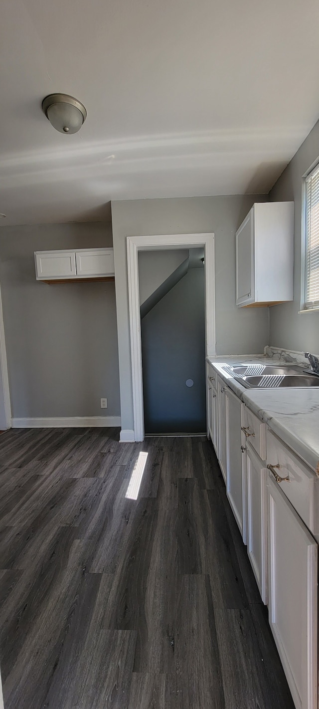 kitchen featuring dark hardwood / wood-style floors, sink, and white cabinets