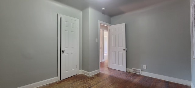 spare room with dark hardwood / wood-style flooring