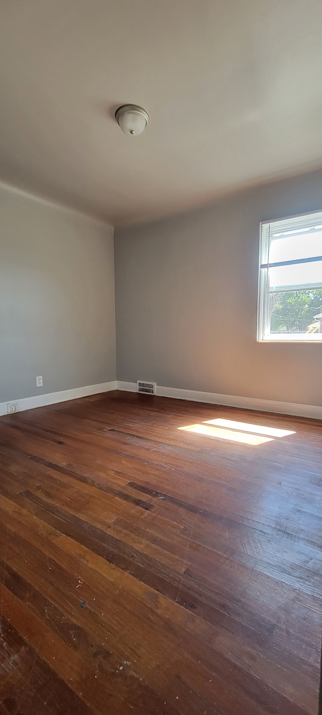 spare room featuring dark hardwood / wood-style floors