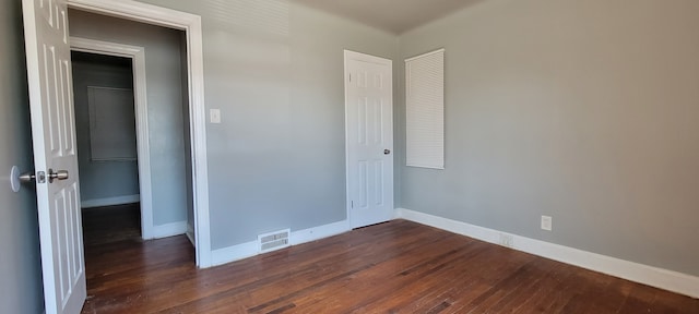 empty room featuring dark hardwood / wood-style flooring