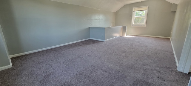 bonus room with carpet floors and vaulted ceiling