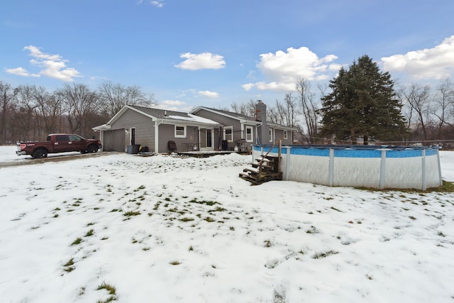 view of snow covered rear of property