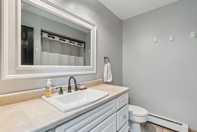 bathroom with vanity, tile patterned floors, baseboard heating, and toilet