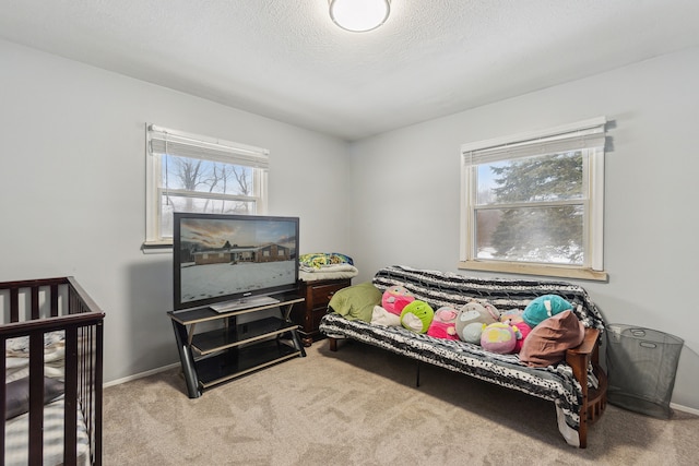 bedroom with light colored carpet and a textured ceiling