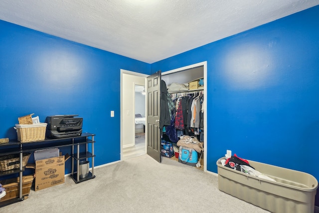 interior space featuring a textured ceiling and carpet