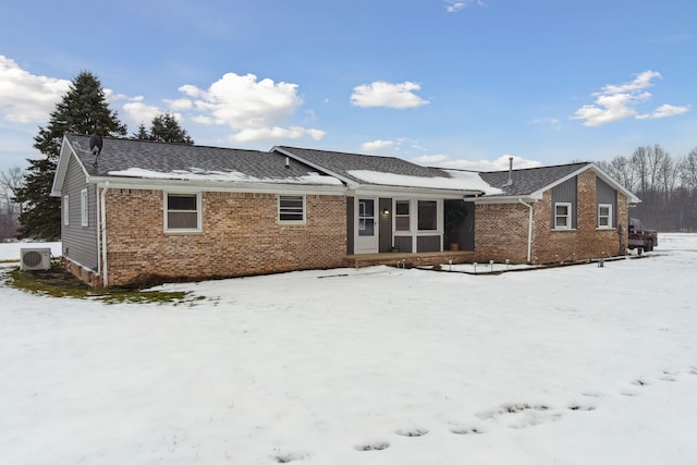 snow covered house with ac unit