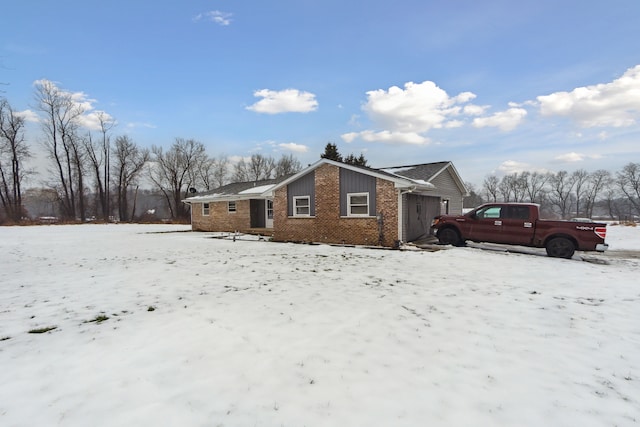 view of snowy exterior featuring a garage