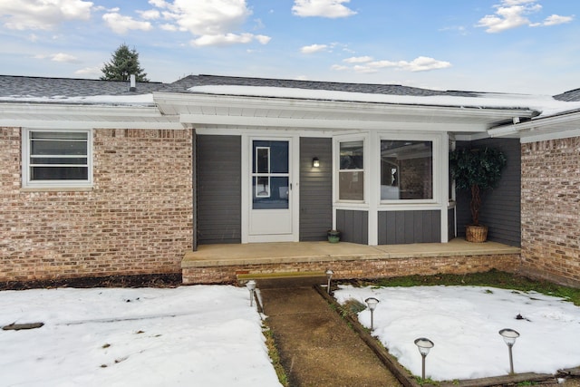 view of snow covered property entrance