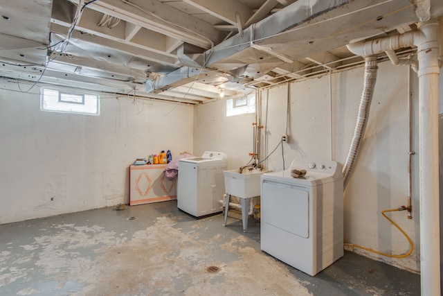 basement with sink and washing machine and dryer