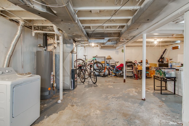 basement featuring heating unit, gas water heater, and washer / clothes dryer