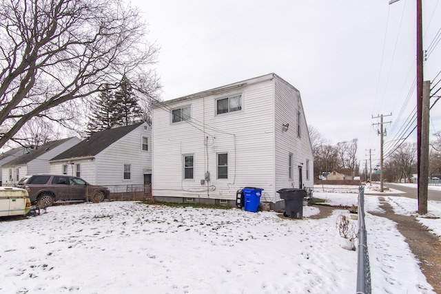 view of snow covered rear of property