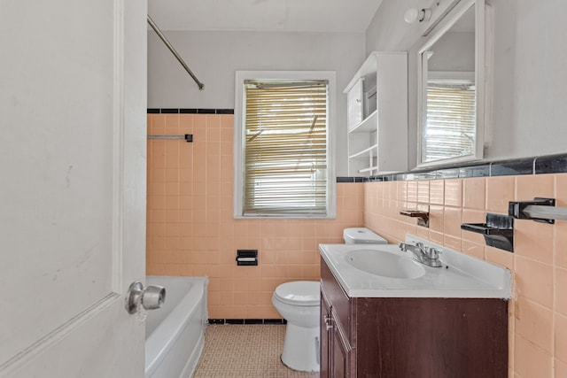 full bathroom with tile patterned flooring, tile walls, vanity, shower / bathing tub combination, and toilet