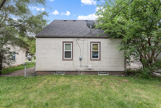 back of house with a lawn