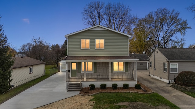 traditional-style home with a porch, an outbuilding, and brick siding