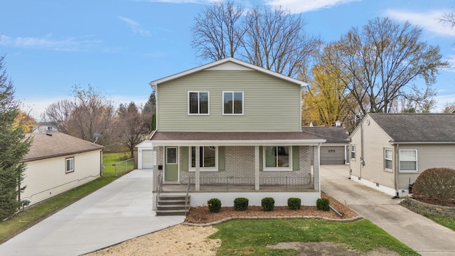 view of front property featuring an outbuilding, a garage, and a porch