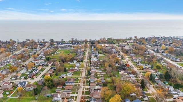 drone / aerial view featuring a water view and a residential view