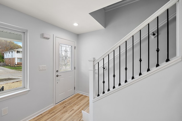 entryway with recessed lighting, baseboards, stairway, and light wood finished floors