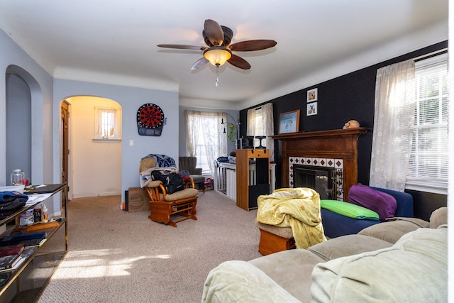 living room featuring ceiling fan, carpet, plenty of natural light, and a fireplace