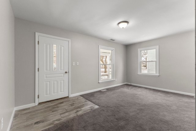 foyer featuring light carpet