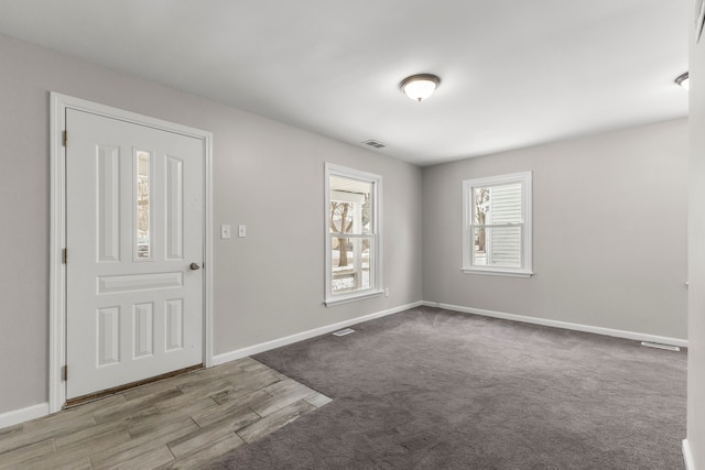 foyer featuring light colored carpet