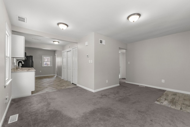 carpeted empty room featuring sink