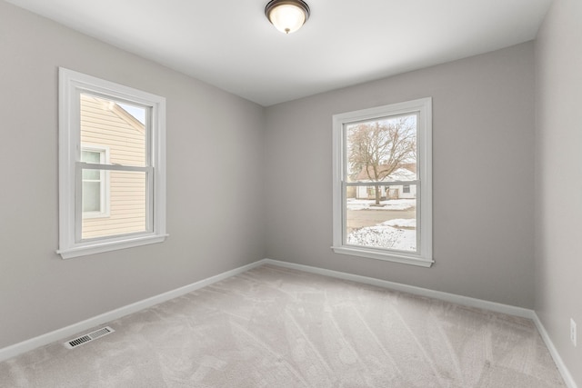 empty room featuring light carpet