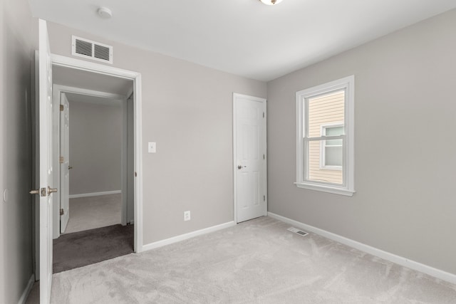 unfurnished bedroom featuring light carpet