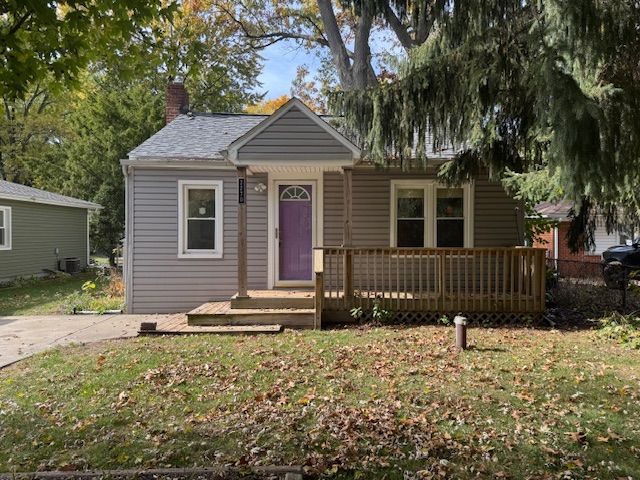 view of front of house with a front lawn and central AC unit