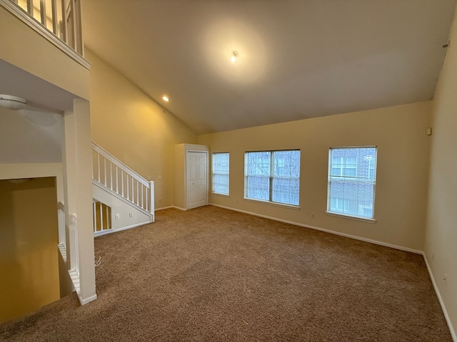 unfurnished room with baseboards, stairs, high vaulted ceiling, and carpet flooring