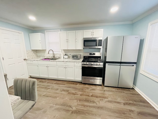 kitchen with white cabinetry, appliances with stainless steel finishes, and sink