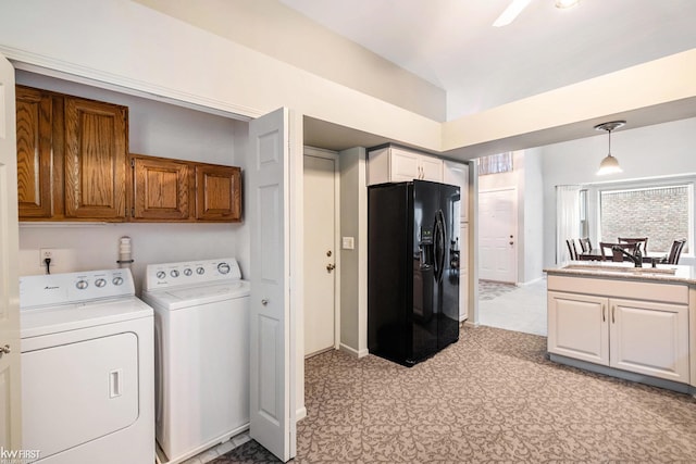 laundry area with sink, cabinets, and independent washer and dryer