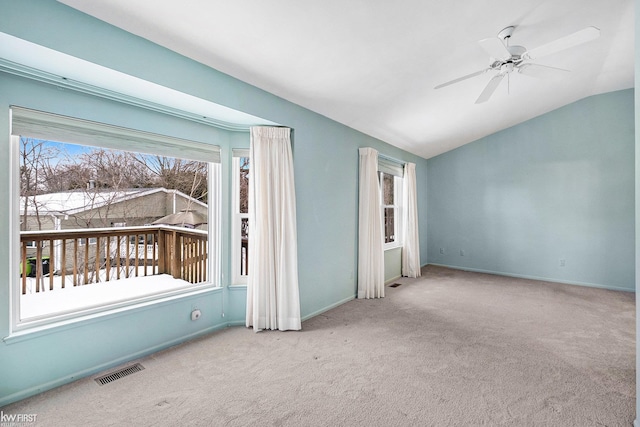 interior space featuring ceiling fan, light carpet, and vaulted ceiling