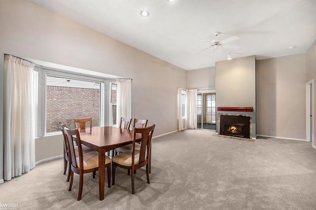 dining area with light carpet and ceiling fan