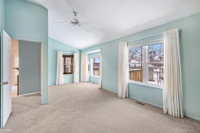 unfurnished room with ceiling fan, light colored carpet, and lofted ceiling