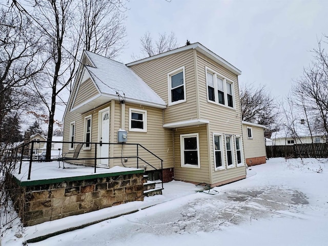 view of snow covered rear of property