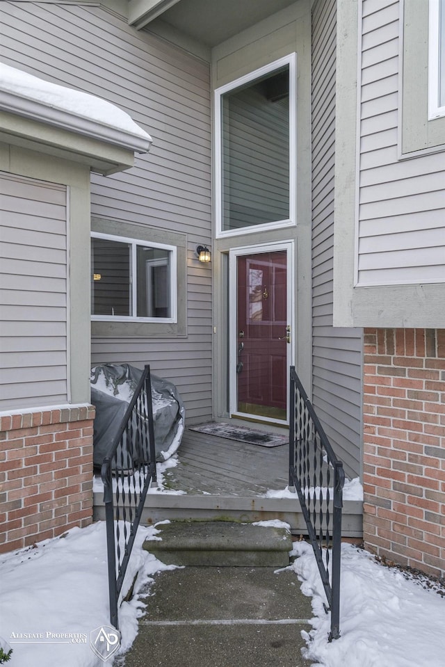 view of snow covered property entrance