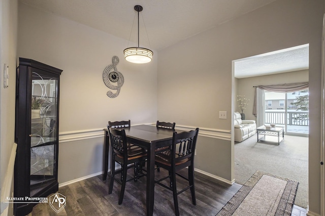 dining space with dark colored carpet