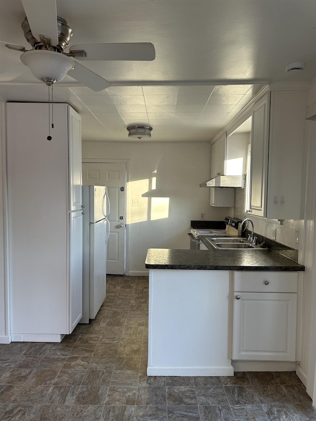 kitchen with sink, white cabinetry, white refrigerator, and electric range oven