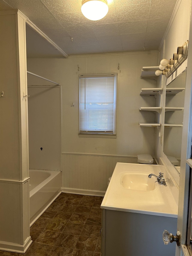 bathroom featuring vanity,  shower combination, and wooden walls