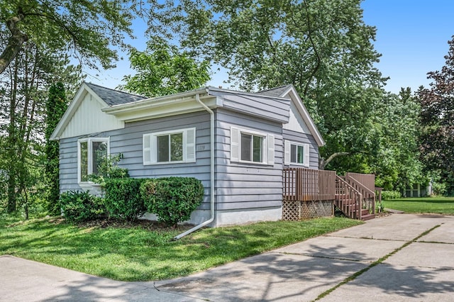 view of side of property with a yard