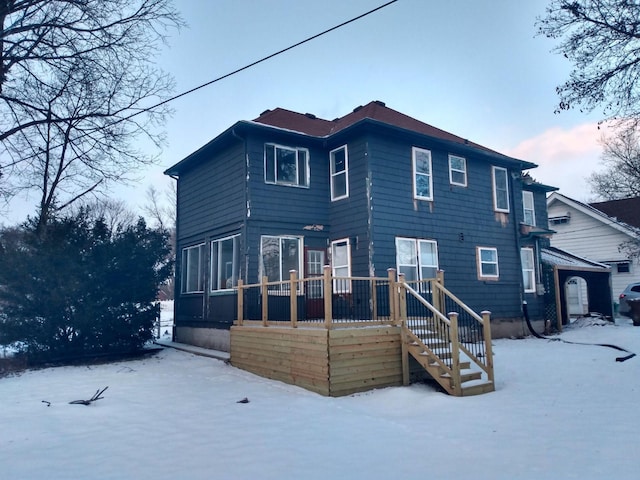 view of snow covered rear of property