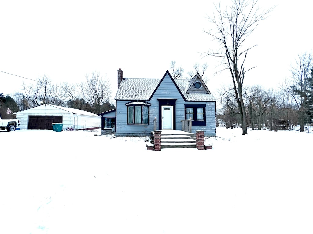 view of front of home with a garage and an outdoor structure