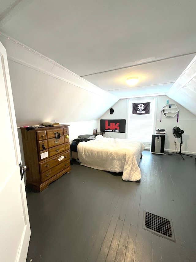 bedroom with wood-type flooring and vaulted ceiling