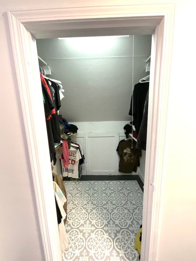 walk in closet featuring lofted ceiling and light tile patterned floors