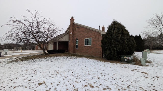 view of snow covered exterior featuring a garage