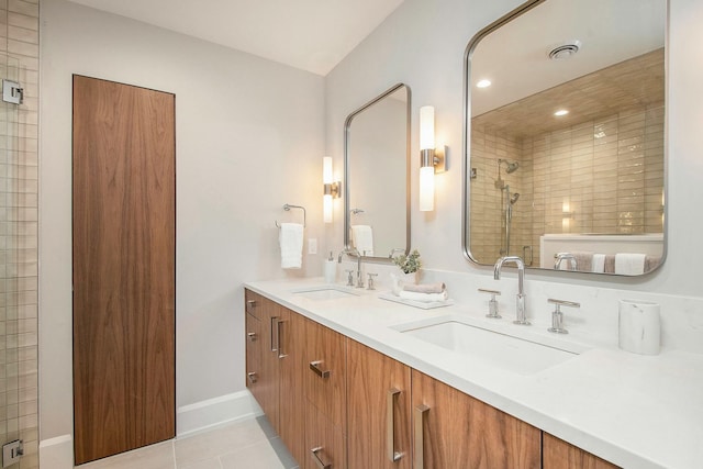 bathroom featuring vanity, a shower, and tile patterned floors