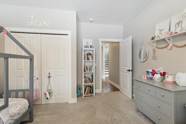 bedroom with light carpet and a closet