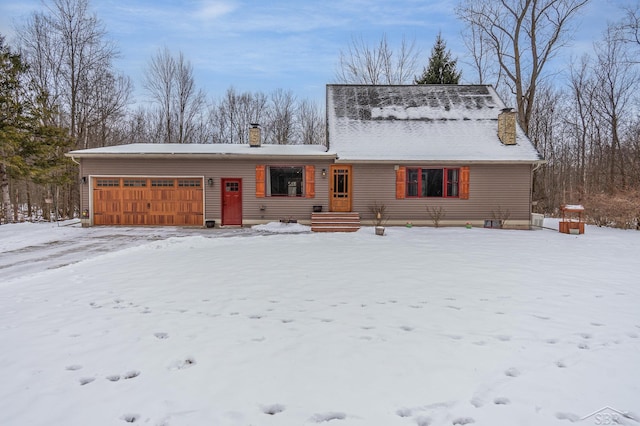 view of front of house featuring a garage and a chimney